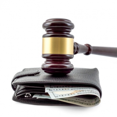 Judge's gavel and wallet with money isolated on white.